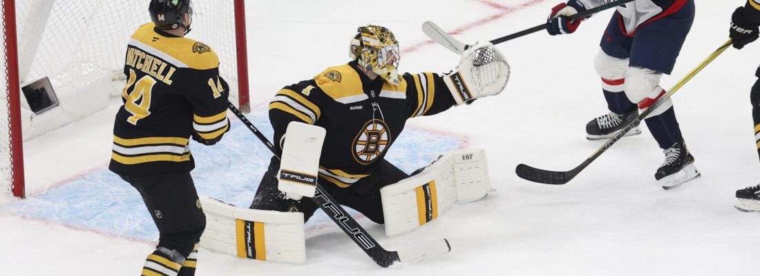 Washington Capitals right wing Ryan Leonard (9) comes up short on a goal as Boston Bruins defenseman Ian Mitchell (14) and goaltender Jeremy Swayman (1) defend the net during the third period of an NHL hockey game, Tuesday, April 1, 2025, in Boston. (AP Photo/Mark Stockwell)