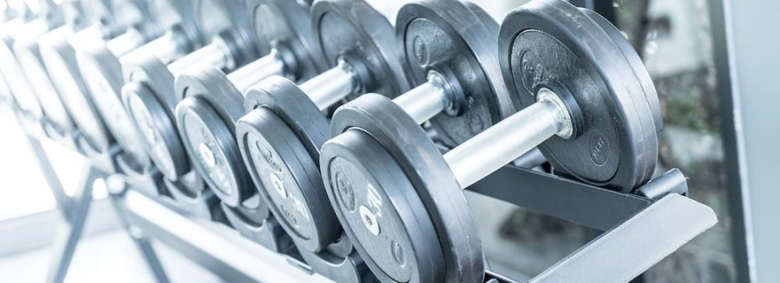 Sports dumbbells in modern sports club. Weight Training Equipment